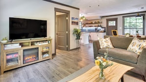 A living room with a TV, fireplace, and a sofa. - Secluded Mountain Retreat: 30 Mi to Asheville! (Old Fort)