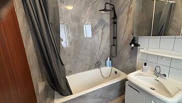 Bathtub, hair dryer, towels