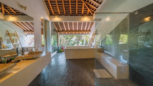A modern bathroom with a wooden ceiling, large windows, and a glass shower enclosure. - Villa Teman-Luxury 4BR Villa in Seminyak (Seminyak)