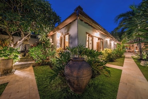 Stroll through lush gardens to a modern building with clean lines and a flat roof.