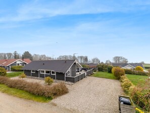 Zona residencial con casas, camino de grava y cielo despejado.