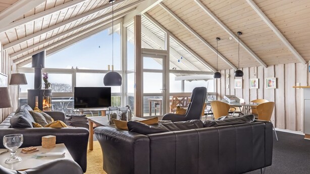 A spacious living area with a large sofa, a TV, and a fireplace. - "Hera" - 200m from the sea by Interhome (Sydals)
