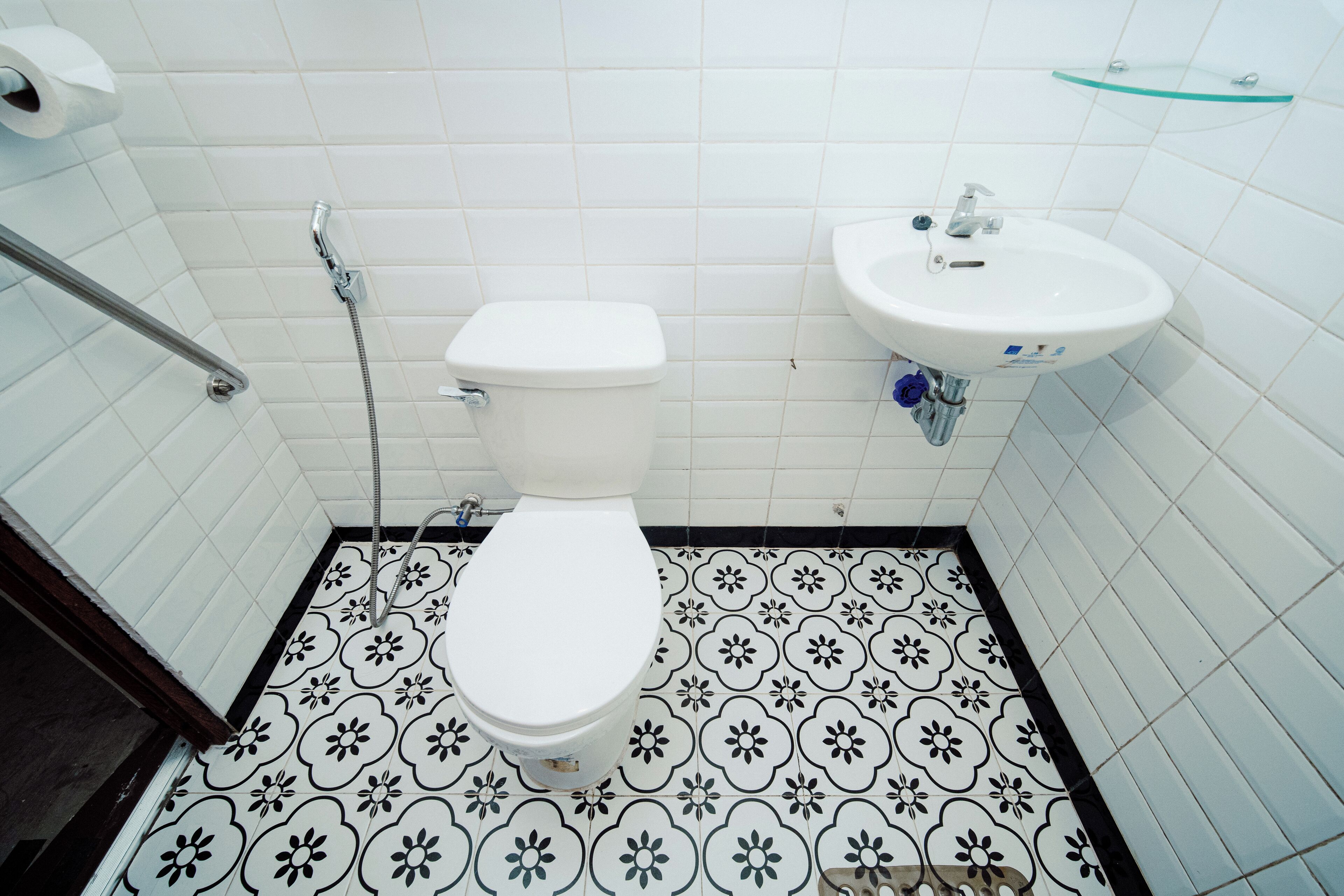 A bathroom with a toilet, a sink, and a shower.