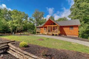 A wooden cabin with a porch, surrounded by a well-maintained lawn and trees. - Cabin Near Blue Ridge w/ Fire Pit & Large Deck (Mineral Bluff)