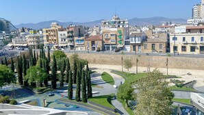 A cityscape with a variety of buildings, including a skateboarding shop. - Phaedrus Living Plateia Suite Grigio (Nicosia)