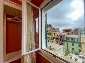 A room with a window overlooking colorful buildings.