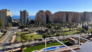 A high-rise building complex with multiple residential units, a central green space with a pool, and a view of the ocean. - ACV - Torremar-2nd floor line 5 Front 4 (OROPESA)