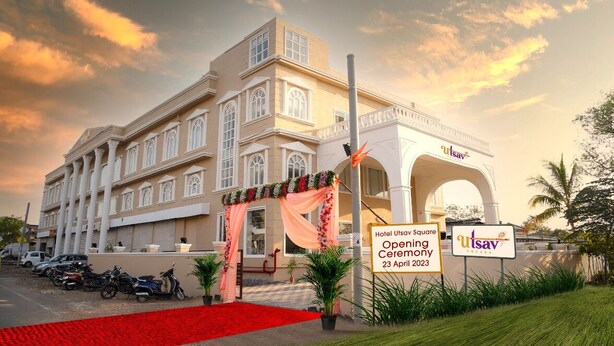 Un hotel con una entrada imponente, una alfombra roja y un cartel que anuncia una ceremonia de inauguración el 23 de abril de 2023.
