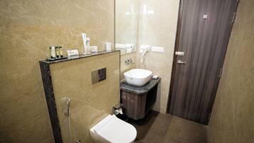 A modern bathroom with a toilet, sink, and shower.
