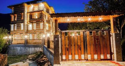 Stone and wood cosy chalet admist apple garden with a beautiful law