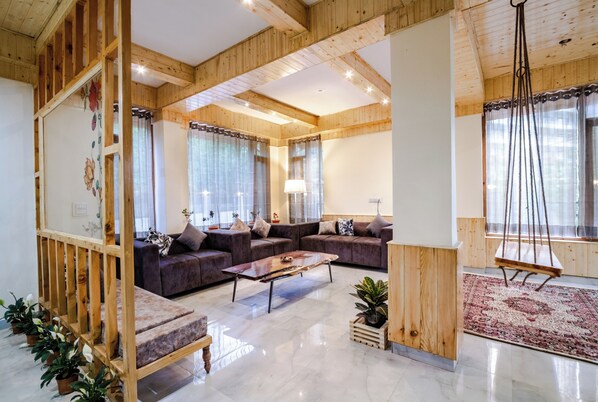Interior - Stone and wood cosy chalet admist apple garden with a beautiful law (Manali)