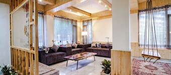 Stone and wood cosy chalet admist apple garden with a beautiful law