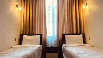 Economy Twin Room | Minibar, in-room safe, desk, laptop workspace