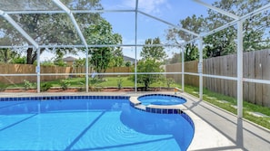 A clear blue pool with a safety fence, surrounded by a wooden fence and greenery. - Experience Luxurious Living: Exquisite Pool House in Brandon for 15 Guests (Brandon)