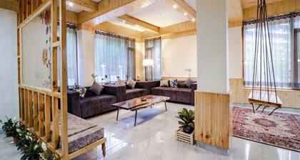 Bedroom in a stone and wood chalet admist apple garden