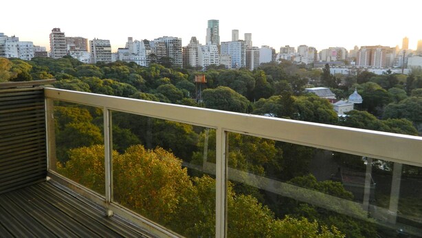 A cityscape with dense greenery and high-rise buildings in the background. - Outstanding apartment with amazing views in heart of Palermo verde (Buenos Aires)