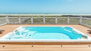 A hot tub on a wooden deck with a view of the ocean. - Beachfront w/POOL ON DECK, Private Dune Walkover, 5 Bedrooms (Galveston)
