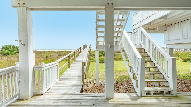 A wooden deck leading to a staircase. - Beachfront w/POOL ON DECK, Private Dune Walkover, 5 Bedrooms (Galveston)