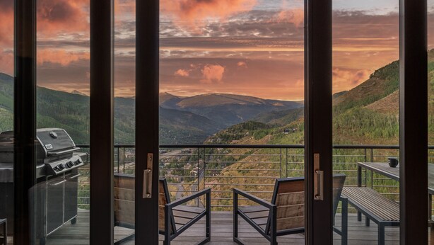 A balcony with a view of a mountainous landscape, a grill, and seating. - Perfect Perch With All the Views | Radiance Retreat (Vail)