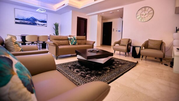 A modern living room with a sofa set, a coffee table, and a rug. - Luxury 3-Bedroom Apartment at Eko Pearl, Eko Atlantic, Victoria Island, Lagos. (Lagos)