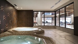 A spa area with two hot tubs, a large window, and a view of the outside. - Wifi, 50m from ski lifts, fitness, swimming pool, sauna, hammam, balcony, ski locker, 90m², Chamonix (Chamonix-Mont-Blanc)
