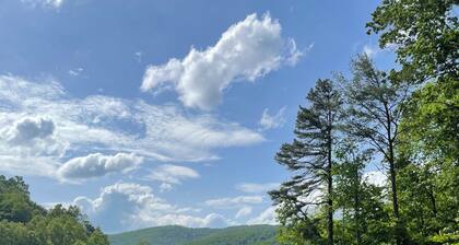 Secluded Cabin with a mountain view, hot tub, full kitchen, and living room.