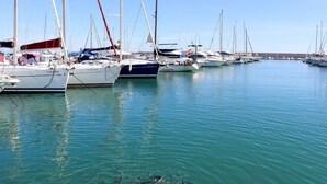 A marina with multiple sailboats docked in calm waters. - 5 bed villa with pool in Cerros de Aguila (Mijas Costa)