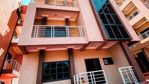 A multi-story building with balconies and large windows. - One bedroom apartment East legon  (Accra)