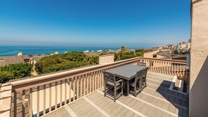 A balcony with a table and chairs overlooking a coastal cityscape. - Ocean View Condo w/ Beach Access!Walk to Del Mar Track/Fair & Solana Train Stop (Solana Beach)