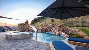 A hot tub surrounded by stone walls and a wooden deck. - Escape to paradise in Texas Hill Country (Harker Heights)