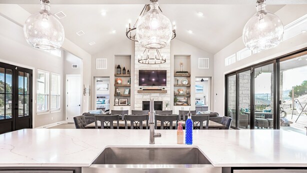A spacious kitchen with a large island, a built-in TV, and a stone fireplace. - Escape to paradise in Texas Hill Country (Harker Heights)
