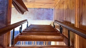 A wooden staircase with metal railings, leading to a tiled wall. - Tartaruga Boutique Hotel & Bungalows (Sile)