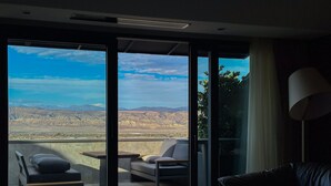A modern room with a balcony, a leather sofa, and a small table. - Chateau MephisKalaki (Kaspi)