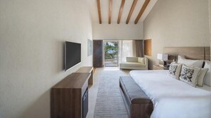 Une chambre d’hôtel moderne dotée d’un grand lit, d’une télévision à écran plat, d’un canapé et offrant une vue sur l’extérieur.