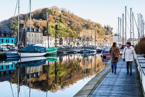 Stroll along the marina's wooden walkway, surrounded by a variety of boats and scenic views.
