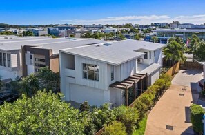 Stylish building with a flat roof, minimalist design, and a landscaped environment.