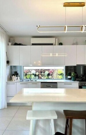 Enjoy cooking in this well-lit kitchen with a large island and dishwasher.