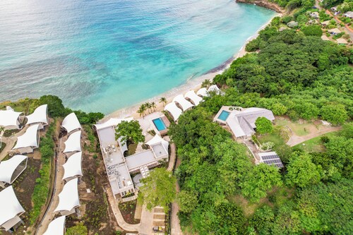 Roomy [1,001 sq ft] two bedroom Unit, steps away from white sand beach.