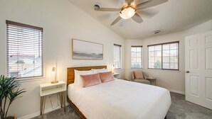 A bedroom with a large bed, a ceiling fan, and multiple windows with blinds. - #HabitueHomes  - The Touchdown - Near BSU! (Boise)
