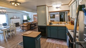 A compact living space with a kitchenette, dining area, and seating area.