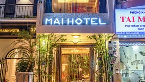 A hotel entrance with a sign reading "MAIHOTEL" and a well-lit facade. - Mai Hotel  (Hanoi)