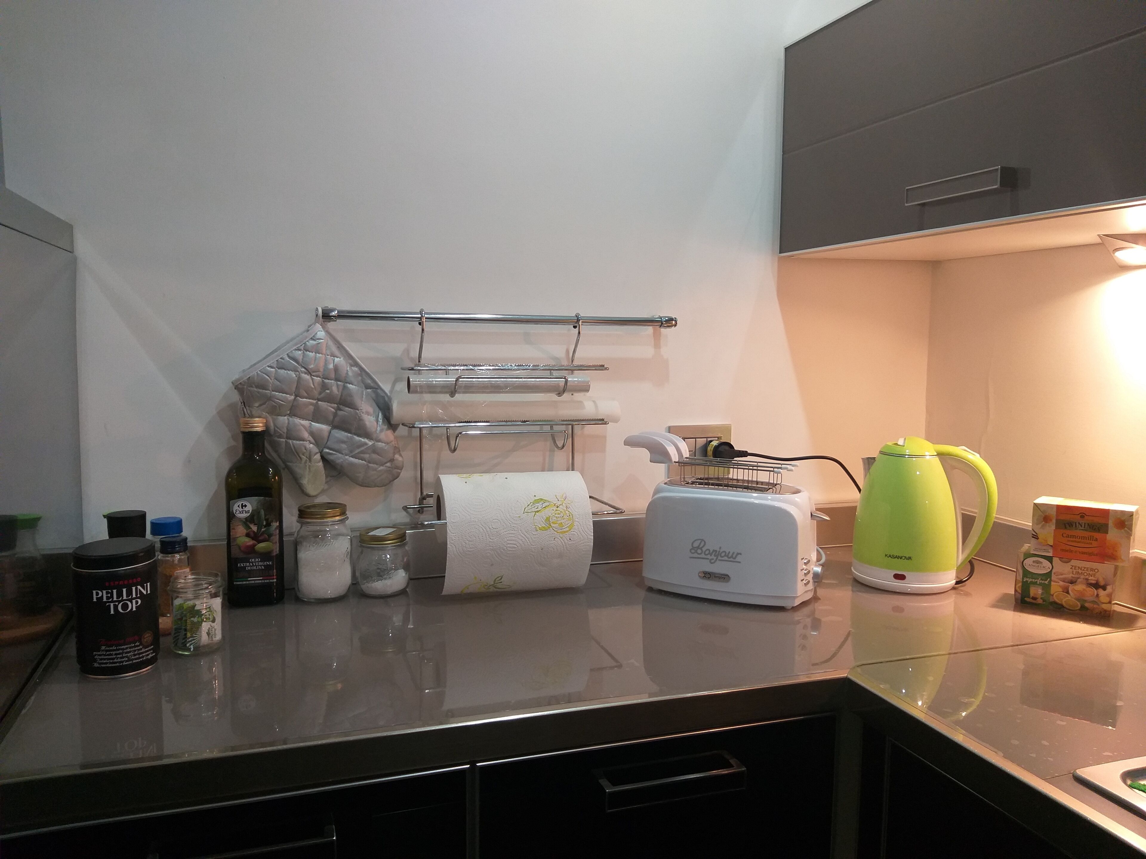 A kitchen with a toaster, kettle, and various kitchen items on the counter.