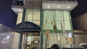 A building with a sign reading "Paris Residential Service."