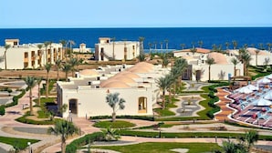 A resort with multiple buildings, palm trees, and a pool area. - Amarina Queen Resort & Aqua Park Marsa Alam (Marsa Alam)