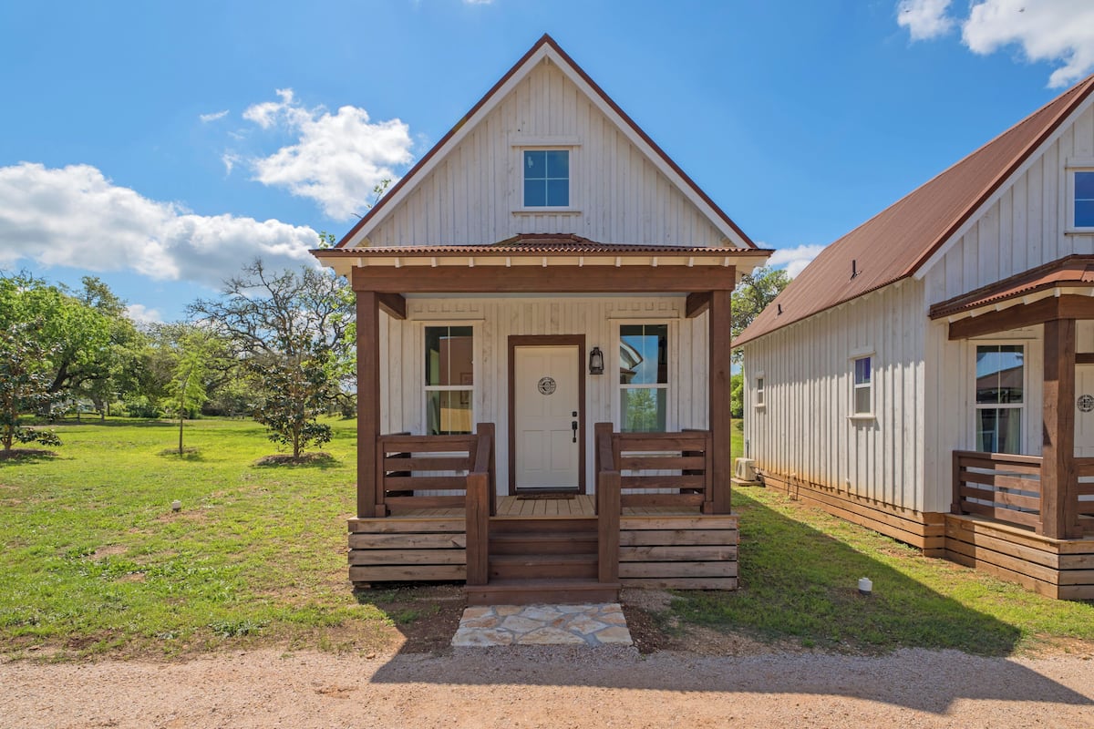 A small, single-story wooden building with a gabled roof and a front porch.