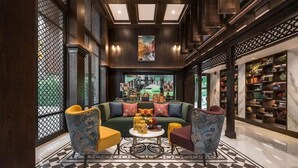 A luxurious lobby with a green sofa, patterned armchairs, and a marble floor. - The Base Central Phuket- 6 Floor (Wichit)