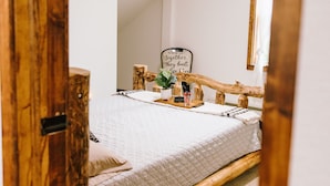 A bedroom with a bed, a bedside table, a mirror, and a sign on the wall. - Come Visit “Mint To Be”
 (Somerset)