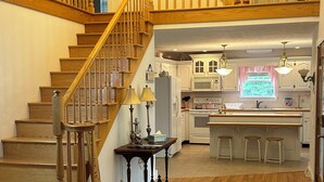 A spacious kitchen with wooden flooring, a central island, and a built-in stove. - The Victorian @ Lake Cumberland - Beaver Creek, firepit, sleeps 18 (Monticello)