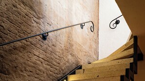 A wooden staircase with a unique design, leading to a higher level.