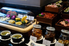 A buffet with various food items including cheeses, meats, and condiments. - Le Chanvre Hanoi Hotel & Spa (Hanoi)